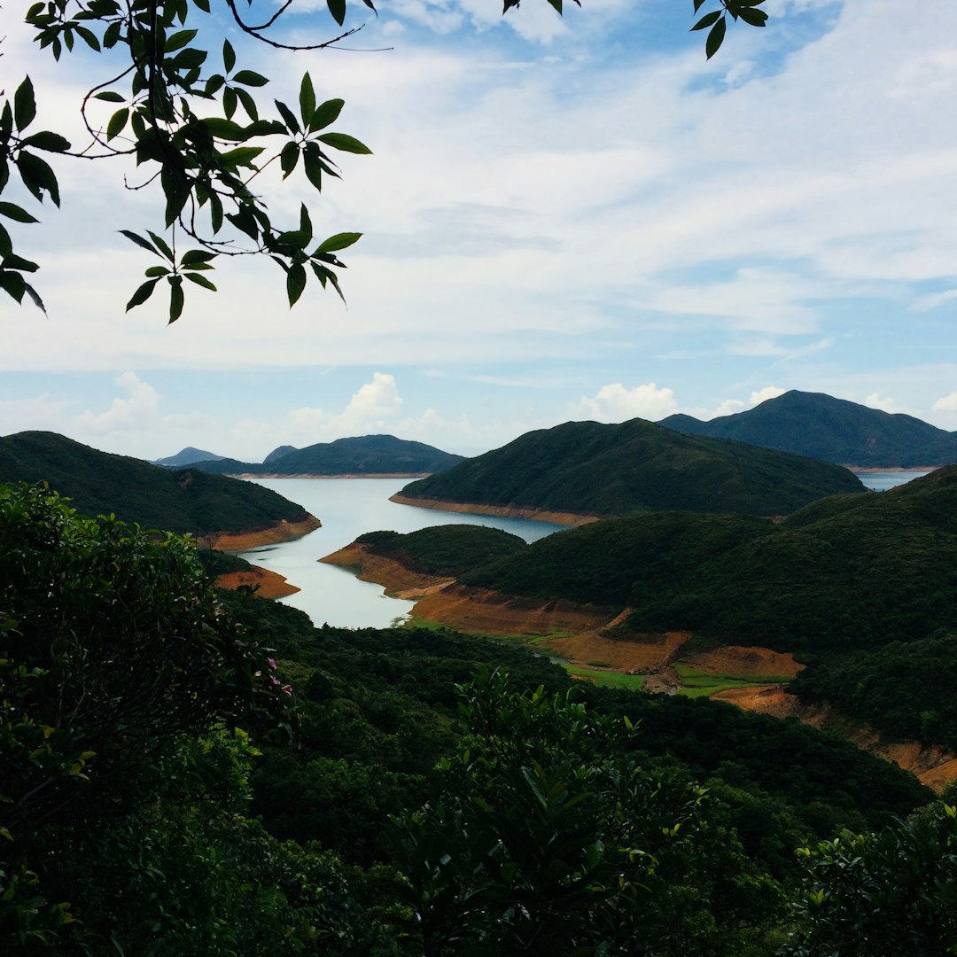 green mountains near body of water during daytime