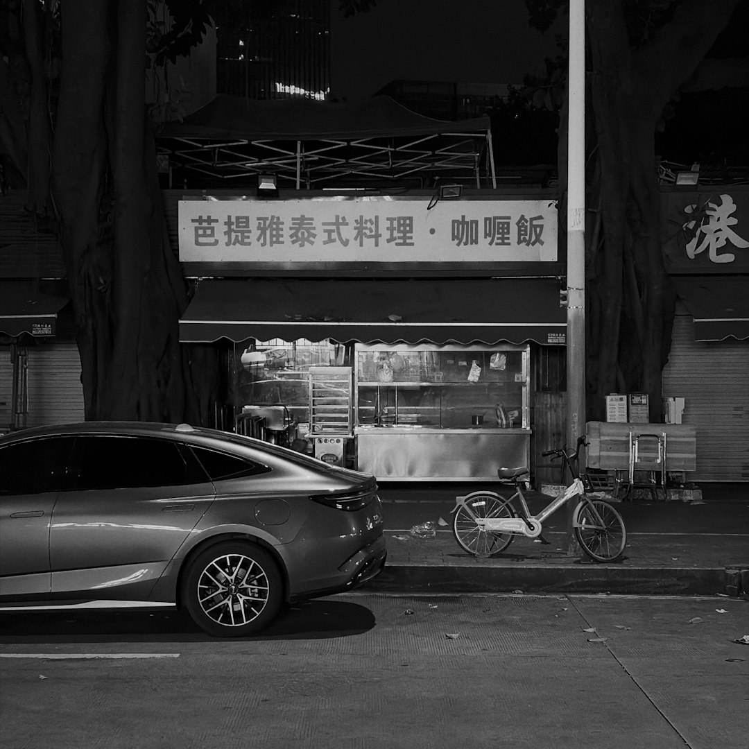 Car parked near a street food stall at night