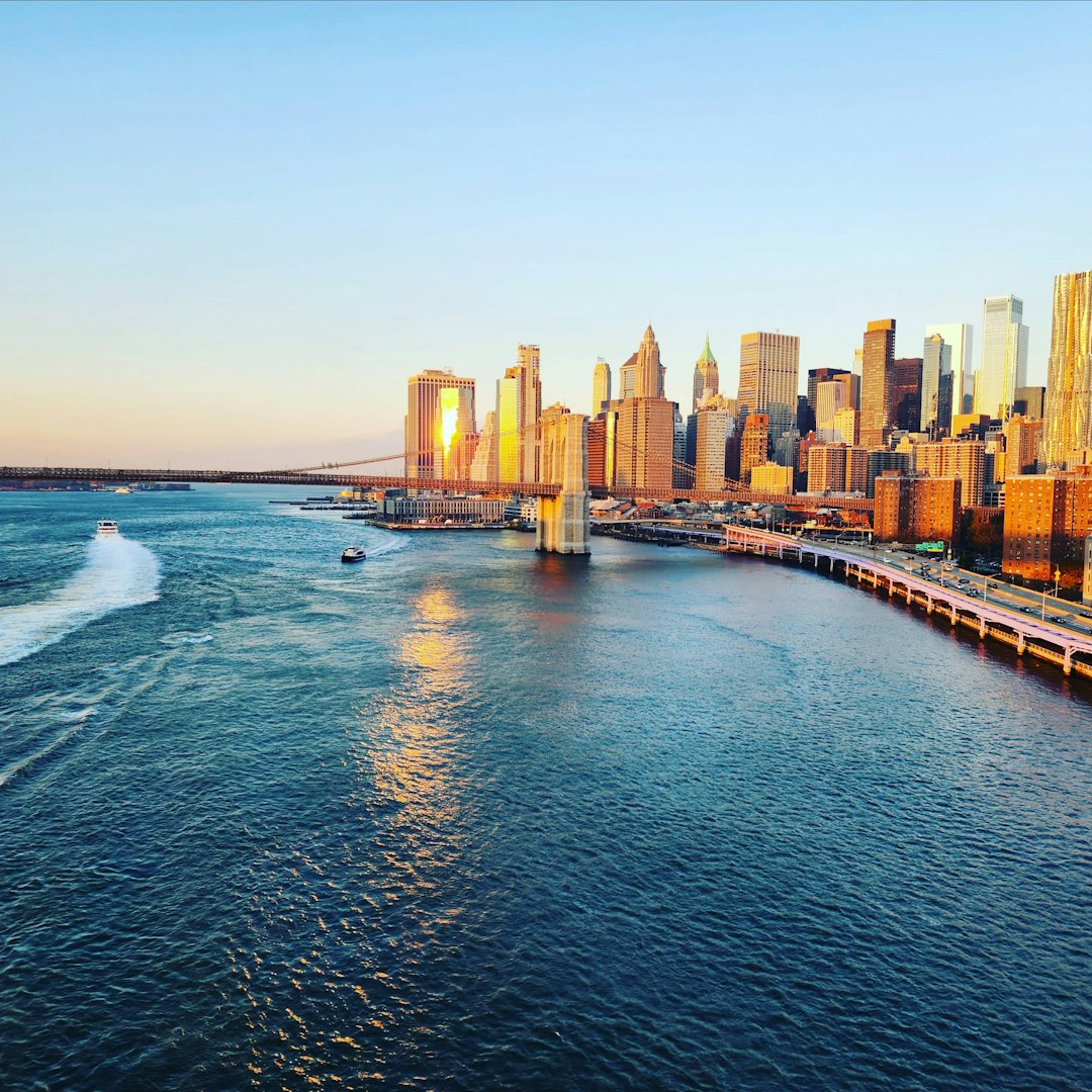 a city skyline with a body of water in front of it