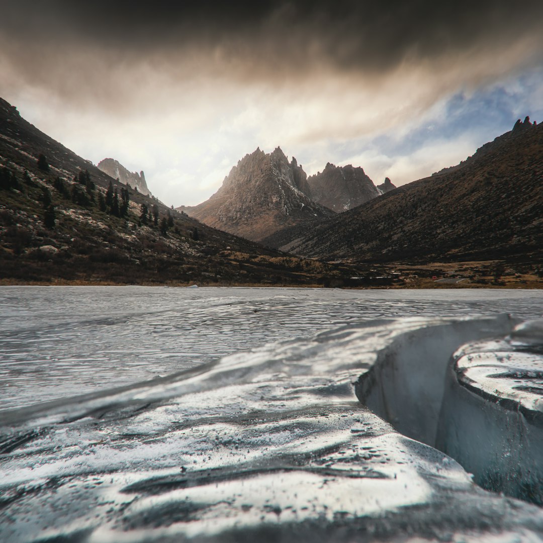 Cracked ice on a frozen lake with mountains