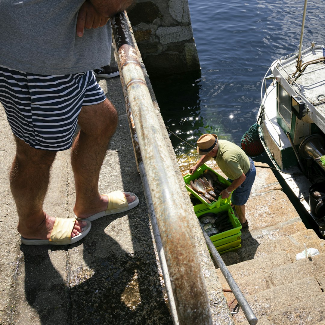 Fishermen unloading crates of fish from a boat