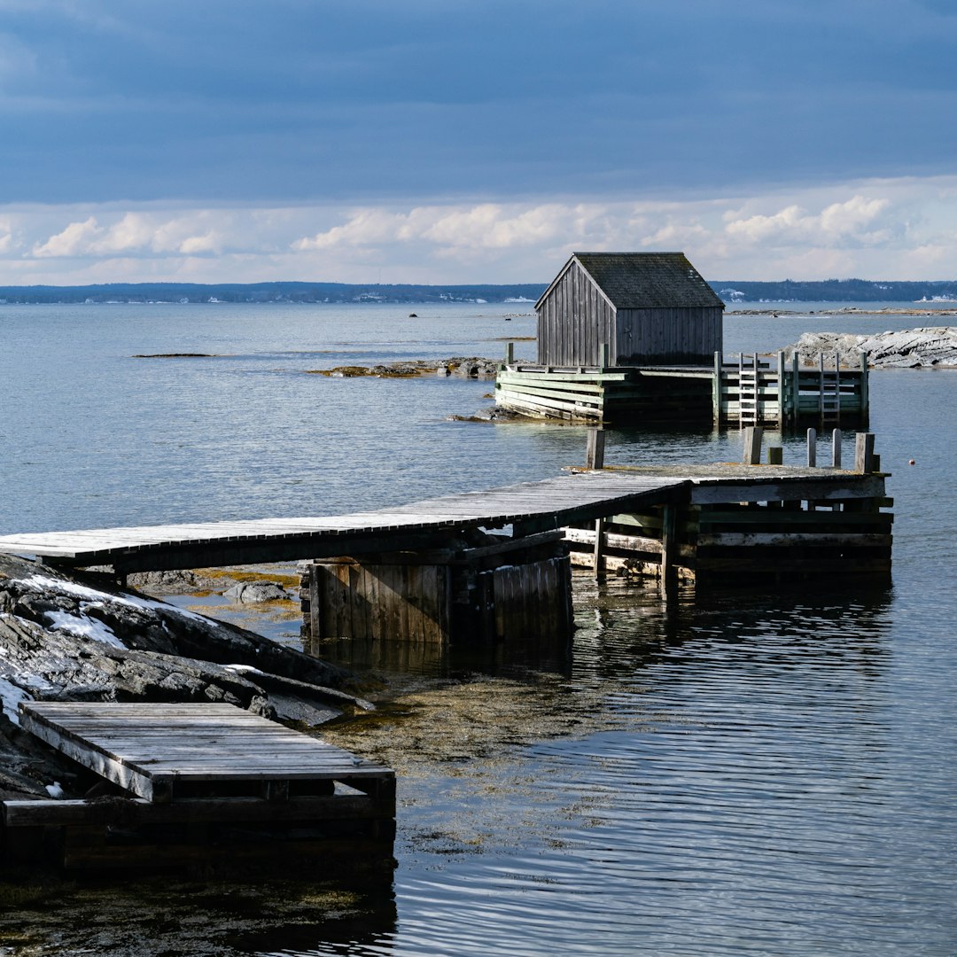 a boat dock with a house in the water