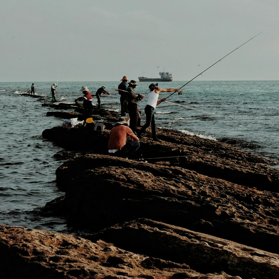 Fishermen casting lines from rocks into the ocean