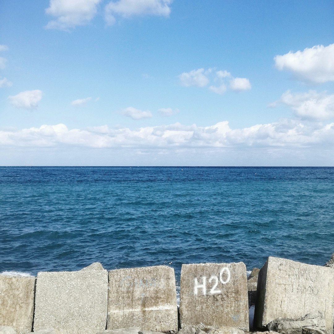 brown wooden dock on blue sea under blue sky during daytime