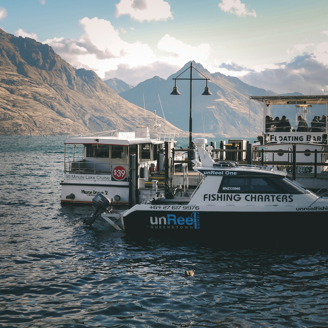 white and blue boat on water during daytime