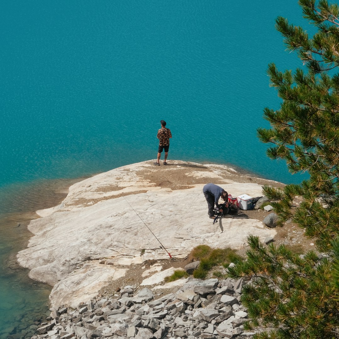 a man and a dog on a rocky beach
